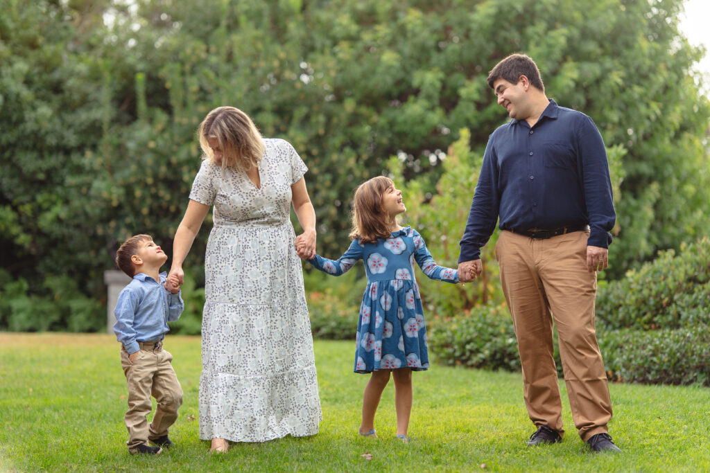 four family members outdoors looking at each other