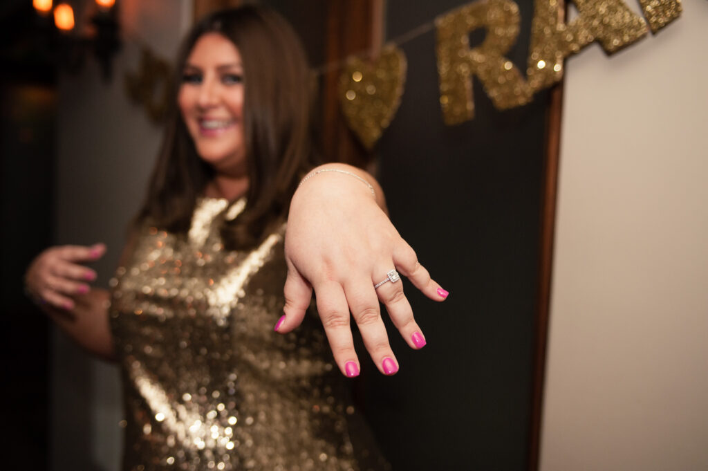 woman showing off her diamond engagement ring